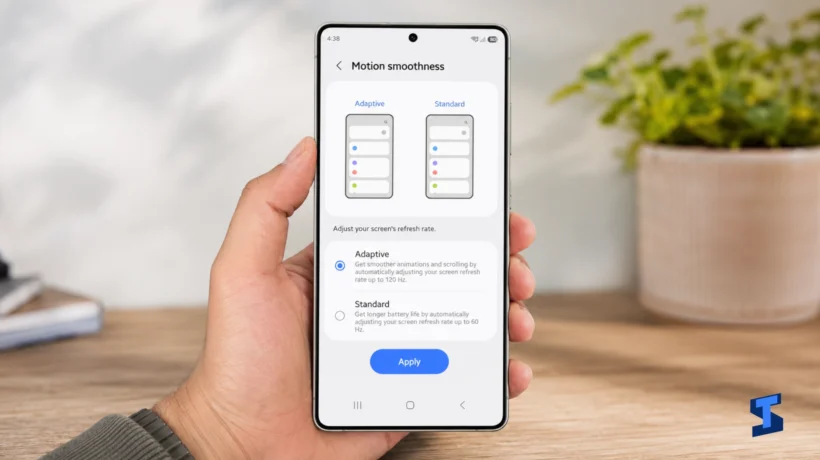 The owner holds a Galaxy S26 Ultra displaying the Motion smoothness settings, with Adaptive refresh rate up to 120Hz selected and Standard 60Hz mode shown below.