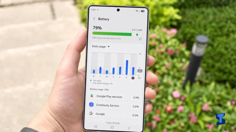 The owner holds a Galaxy S26 Ultra displaying the Motion smoothness settings, with Adaptive refresh rate up to 120Hz selected and Standard 60Hz mode shown below.